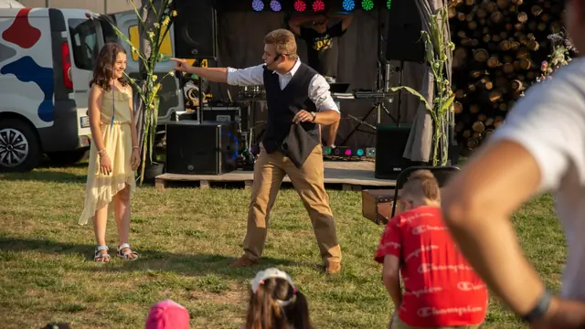 Bartosz Rybczyński z uczestniczką rodzinnego pokazu iluzji w plenerze